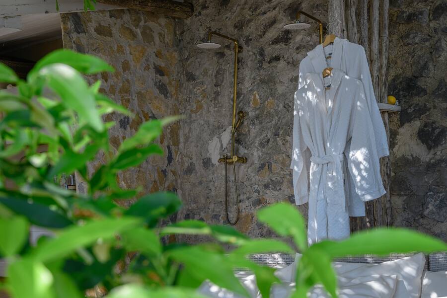 The open-air shower among the lemon trees, and the olive garden suspended above the sea.